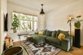 a living room with a green couch and a rug Royalty Free Stock Photo