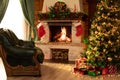 Christmas living room interior in the day time with decorated fireplace, armchair and xmas tree Royalty Free Stock Photo
