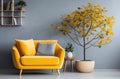 living room and home office with yellow chair, blue couch and grey tree Royalty Free Stock Photo