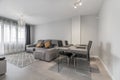 Living room of a house with gray wooden dining table with matching chairs Royalty Free Stock Photo