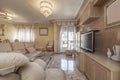 Living room of a house with a sofa with a luminous chaise longue upholstered in beige fabric