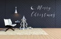 Living room interior with black wall and white Christmas tree and Merry Christmas word on wall for Christmas holiday Royalty Free Stock Photo