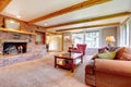 Living room interior with brick fireplace, wood beams and red. Royalty Free Stock Photo