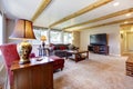 Living room interior with brick fireplace, wood beams and red. Royalty Free Stock Photo