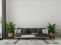 Grey sofa and plants decor against beige wall background. Minimal home interior design of cozy living room. Royalty Free Stock Photo