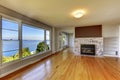 Living room interior with hardwood floor, fireplace and water vi Royalty Free Stock Photo