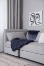 Living room interior with knitted merino wool blanket on sofa Royalty Free Stock Photo