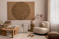 Living room interior with mock up poster frame, beige sofa, round wooden coffee table, rug, pouf, vase with rowan, rounded shapes Royalty Free Stock Photo