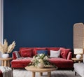 Living room interior mock-up with red sofa, wooden table and rattan home decoration in dark blue background