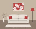 Living room interior in red and beige colors. There is a sofa with pillows, a red floor lamp, and a picture with cherry flowers Royalty Free Stock Photo