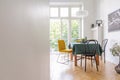 Living room interior with table cloth and different kind of chairs, black map on the wall, real photo with