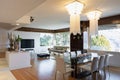 Living room with lacquered wood furniture and lake view window