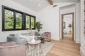 Living room with large window featuring cozy sofa and two armchairs