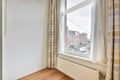 a living room with a large window and striped curtains Royalty Free Stock Photo