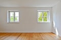 Living room in an old building - Apartment with wooden windows and parquet flooring after renovation Royalty Free Stock Photo