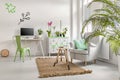 Living room with plants, commode and armchair Royalty Free Stock Photo