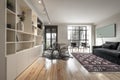 Living room with round glass dining table, designer gray chairs,