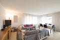 Living room with sofas, table with chairs to eat and a modern kitchen