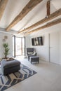 Living room with sofas and tv in an attic with vaulted ceilings