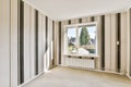 a living room with striped walls and a window Royalty Free Stock Photo