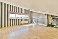 a living room with stripped walls and a wood floor Royalty Free Stock Photo