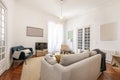 Living room with three-seater sofa upholstered in fabric with Royalty Free Stock Photo