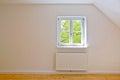 Living room on the top floor, apartment with wooden windows and parquet flooring after renovation