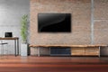 Living room tv on red brick wall with wooden table