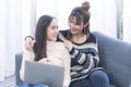 In the living room, two women use laptops and look into each other`s eyes. Royalty Free Stock Photo