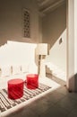 A living room with white furniture and red stools on top of the carpet Royalty Free Stock Photo