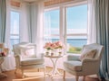 A living room with 2 wingback chairs with stained wood legs in front of a large window overlooking the ocean.