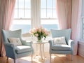 A living room with 2 wingback chairs with stained wood legs in front of a large window overlooking the ocean.