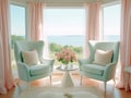 A living room with 2 wingback chairs with stained wood legs in front of a large window overlooking the ocean.