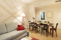 Living room with wooden dining table with black chairs and tableware