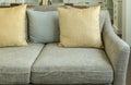 Living room with yellow and gray pillows on velvet gray sofa Royalty Free Stock Photo