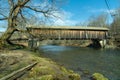 Livingston Manor, NY / United States - April 19, 2020: A side view of the Livingston Manor Covered Bridge spanning the scenic Royalty Free Stock Photo