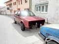 Livno / Bosnia and Herzegovina - June 28 2017: A view of a typical street in Livno. Disassembled cars on the roadside