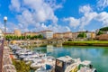 Colorful houses and boats on the waterfront port in Livorno, Tuscany, Italy