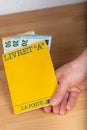Livret A, `Laposte` postal savings book in the hand of a person