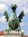 Ljubljana, L, Slovenia - August 16, 2023: Winged dragon symbol of city on bridge called zmajski most in slovenian