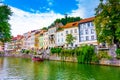 Ljubljana old town center, view of Ljubljanica river in city center. Old building historic panorama. Look to old bridge with touri