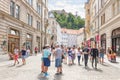 LJUBLJANA, SLOVENIA - AUGUST 15, 2018: A large cobbled pedestrian street with high old buildings presents the city Castle to the Royalty Free Stock Photo