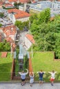 Ljubljana, Slovenia - August 15, 2018: Some people watch the Castle Funicular from above riding up the castle's hill