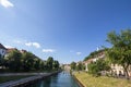 Panorama of Ljubljanica river in the city center of Ljubljana with a bridge in background in summer.
