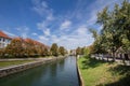 Panorama of Ljubljanica river in the city center of Ljubljana with a bridge in background in summer.