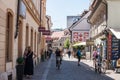 Bicycle passing by Trubarjeva cesta street in the afternoon with people passing by and nearby shops. Royalty Free Stock Photo