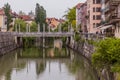 LJUBLJANA, SLOVENIA - MAY 14, 2019: Riverside buildings and the Cobblers bridge in Ljubljana, Sloven Royalty Free Stock Photo