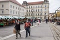 Selective blur on Old senior man and woman, couple, wearing a facemask, waking in street of Ljubljana Central Market during covid Royalty Free Stock Photo