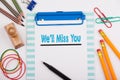 We`ll Miss You. White office desk with stationery Royalty Free Stock Photo