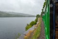 Llanberis Lake and Snowdonia mountains in the light rain seen from slow moving steam train - 2